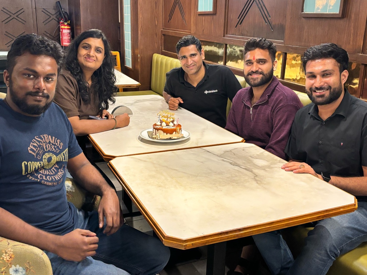 The team gathered around a cake for a birthday celebration
