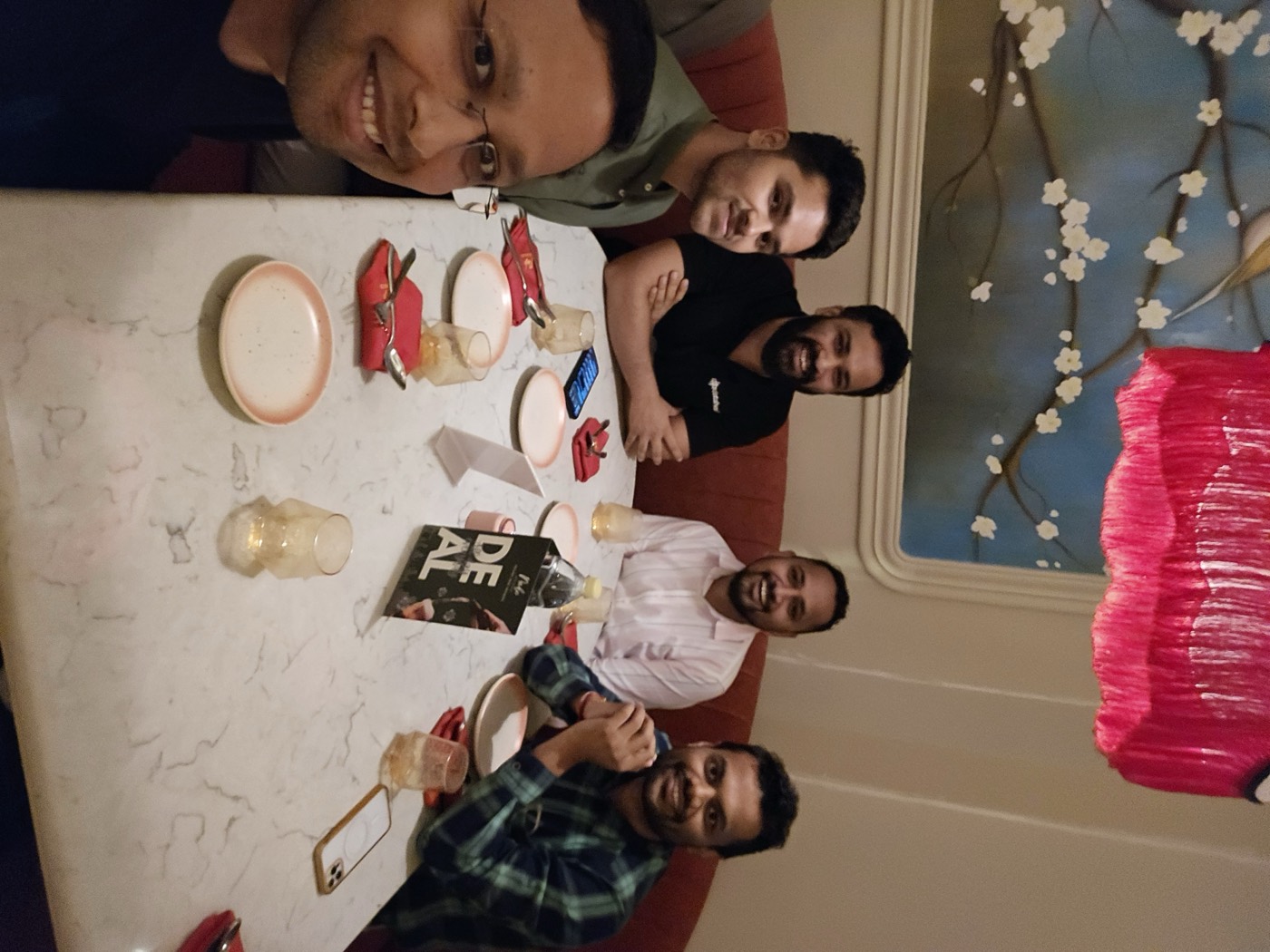 Teammates around a table sharing dinner on an evening out
