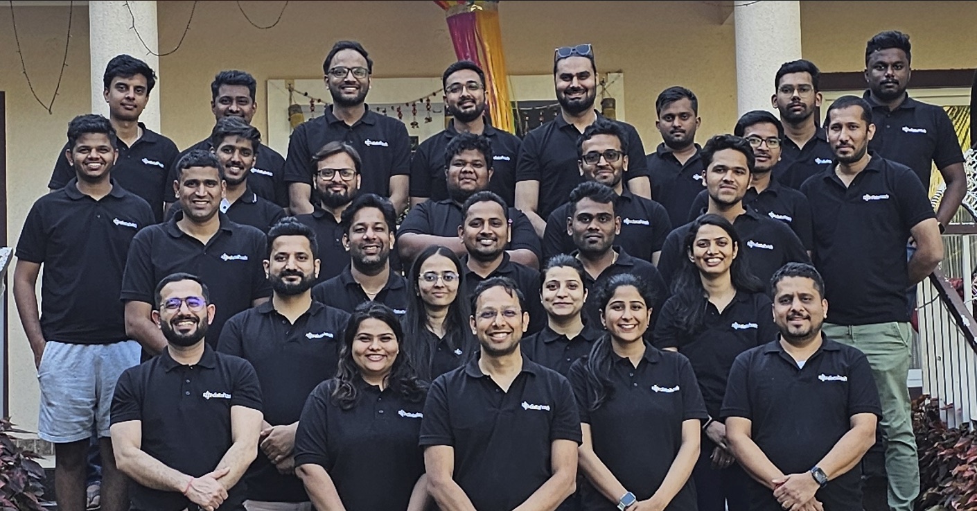 The Datahash team gathered on the steps of the company offsite, everyone in branded polos.